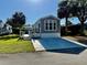 Cozy single Gathering home with a driveway and well-manicured lawn on a sunny day at 3067 Ne 102Nd Avenue Rd, Silver Springs, FL 34488