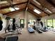 The gym features vaulted wood ceilings, ceiling fans and modern exercise equipment at 3067 Ne 102Nd Avenue Rd, Silver Springs, FL 34488