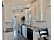 Cozy kitchen with white cabinets, modern appliances, and a view into the dining area at 3067 Ne 102Nd Avenue Rd, Silver Springs, FL 34488