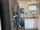 Modern kitchen featuring stainless steel appliances, white cabinets, and tile backsplash at 3067 Ne 102Nd Avenue Rd, Silver Springs, FL 34488