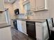 Well-lit kitchen featuring white cabinets, modern appliances, and open dining area at 3067 Ne 102Nd Avenue Rd, Silver Springs, FL 34488