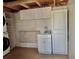 Inside the laundry room are modern washer and dryer, sink and folding counter at 3067 Ne 102Nd Avenue Rd, Silver Springs, FL 34488