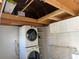 Modern laundry room with washer/dryer, cabinets, folding counter, and storage shelves at 3067 Ne 102Nd Avenue Rd, Silver Springs, FL 34488