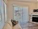 Inviting living room featuring a comfortable couch, modern fireplace, and large windows at 3067 Ne 102Nd Avenue Rd, Silver Springs, FL 34488