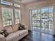 Bright living room with a comfortable couch, large windows, and sliding glass doors at 3067 Ne 102Nd Avenue Rd, Silver Springs, FL 34488