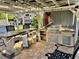 Outdoor kitchen with bar seating, built-in mini-fridge, stainless steel grill and overhead pergola at 3067 Ne 102Nd Avenue Rd, Silver Springs, FL 34488