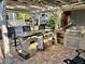 Outdoor kitchen with a mini-fridge, grill, storage, and overhead pergola, ideal for backyard entertaining at 3067 Ne 102Nd Avenue Rd, Silver Springs, FL 34488