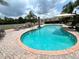 Community pool boasts sun loungers and umbrellas for relaxing and enjoying the Florida sunshine at 3067 Ne 102Nd Avenue Rd, Silver Springs, FL 34488