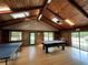 The recreation room features a pool table, ping pong table, and wood-paneled walls at 3067 Ne 102Nd Avenue Rd, Silver Springs, FL 34488