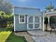 Exterior view of a charming shed with a modern pergola, adding a touch of elegance to the backyard at 3067 Ne 102Nd Avenue Rd, Silver Springs, FL 34488