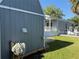 Shed exterior alongside the residence with a well-maintained lawn, blending storage with outdoor living at 3067 Ne 102Nd Avenue Rd, Silver Springs, FL 34488
