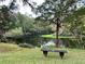 Scenic waterfront view with bench seating overlooking tranquil river surrounded by lush greenery at 3067 Ne 102Nd Avenue Rd, Silver Springs, FL 34488