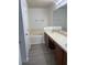 Bright bathroom features a double sink vanity, soaking tub, and wood-look flooring at 3111 Wentworth Ln, Kissimmee, FL 34741