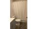 Clean bathroom featuring vanity with gray cabinets and a shower with a white curtain at 3111 Wentworth Ln, Kissimmee, FL 34741