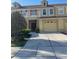Charming townhouse featuring a balcony, two-car garage, and well-maintained landscaping at 3111 Wentworth Ln, Kissimmee, FL 34741