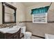 Bathroom featuring stylish tile work, vanity and mirror at 320 Granada Dr, Winter Park, FL 32789
