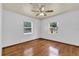 Bedroom with wood floors, ceiling fan and two windows at 320 Granada Dr, Winter Park, FL 32789