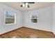 Bright bedroom with wood floors, a ceiling fan and two large windows at 320 Granada Dr, Winter Park, FL 32789