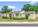 Charming single-story home featuring manicured shrubs and a concrete walkway at 320 Granada Dr, Winter Park, FL 32789