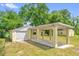 This backyard has a garage with a covered parking area featuring a concrete pad and yellow support beams at 320 Granada Dr, Winter Park, FL 32789