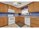 The kitchen features updated appliances, wood cabinetry, and ample counter space at 320 Granada Dr, Winter Park, FL 32789