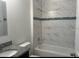 This bathroom features a tub and shower combination and a granite sink at 3389 Sw 126Th Lane Rd, Ocala, FL 34473