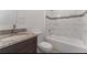 Bathroom featuring a sink with granite counter tops, and a bathtub with tiled walls at 3389 Sw 126Th Lane Rd, Ocala, FL 34473