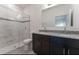 An elegant bathroom with double sinks, a glass-door shower, and modern fixtures at 3389 Sw 126Th Lane Rd, Ocala, FL 34473
