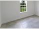 An empty bedroom showing a window with a view of the outdoors and tiled floor at 3389 Sw 126Th Lane Rd, Ocala, FL 34473