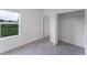 Bedroom featuring a window with a view, tiled floors, and closet at 3389 Sw 126Th Lane Rd, Ocala, FL 34473