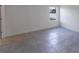This bedroom shows an exterior view through the window and tile flooring at 3389 Sw 126Th Lane Rd, Ocala, FL 34473