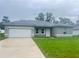 Charming single-story home with a well-manicured lawn and attached two-car garage at 3389 Sw 126Th Lane Rd, Ocala, FL 34473
