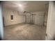 A garage with bare floors and an automatic garage door at 3389 Sw 126Th Lane Rd, Ocala, FL 34473
