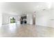Open concept living space showcasing tile floors, kitchen island, stainless appliances, and view to the backyard at 3389 Sw 126Th Lane Rd, Ocala, FL 34473