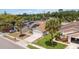 Aerial view of a single-Gathering home with mature trees, a driveway, and solar panels in a residential neighborhood at 357 Kantor Blvd, Casselberry, FL 32707