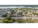 Wide aerial view of a neighborhood with a mix of housing and a lake, highlighting the location of a single-Gathering home at 357 Kantor Blvd, Casselberry, FL 32707