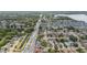 Aerial view of a community with diverse housing options, a major roadway, and a picturesque lake in the background at 357 Kantor Blvd, Casselberry, FL 32707