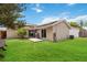 The backyard features a well-maintained lawn, a patio, and a grill, perfect for outdoor enjoyment at 357 Kantor Blvd, Casselberry, FL 32707