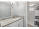 Bathroom with a white vanity, granite countertop, large mirror, updated lighting fixtures, and a walk-in shower at 357 Kantor Blvd, Casselberry, FL 32707