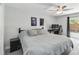 Bedroom featuring grey floors, a ceiling fan, and a sliding glass door to backyard at 357 Kantor Blvd, Casselberry, FL 32707