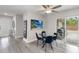 Modern dining room with a glass table, blue chairs, and sliding door access to the backyard at 357 Kantor Blvd, Casselberry, FL 32707