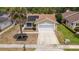 Aerial view of the house highlighting the roof, palm tree, lawn, and solar panels at 357 Kantor Blvd, Casselberry, FL 32707