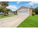 Well manicured lawn with an asphalt driveway leads to the two car garage at 357 Kantor Blvd, Casselberry, FL 32707