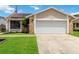 Well maintained lawn leads up to the home with two car garage and stone accents at 357 Kantor Blvd, Casselberry, FL 32707