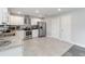 Spacious kitchen boasts stainless steel appliances, modern white cabinets and neutral-toned flooring at 357 Kantor Blvd, Casselberry, FL 32707