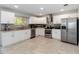 Bright kitchen featuring stainless steel appliances, granite countertops, and white cabinetry at 357 Kantor Blvd, Casselberry, FL 32707