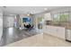 Bright living room with adjacent dining area featuring a ceiling fan and view to outdoor patio at 357 Kantor Blvd, Casselberry, FL 32707
