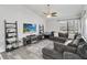 Bright living room with hardwood floors, a ceiling fan, and a large sectional sofa at 357 Kantor Blvd, Casselberry, FL 32707