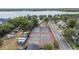Aerial shot showcases tennis courts with RV and boat storage nearby, set against a backdrop of green trees at 357 Kantor Blvd, Casselberry, FL 32707
