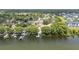 Aerial view of waterfront homes with private docks on a serene lake, surrounded by lush greenery and mature trees at 357 Kantor Blvd, Casselberry, FL 32707